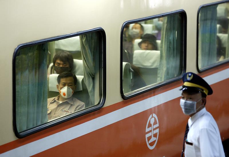 2003年5月的台北車站，因應SARS疫情的發展，旅客與站務人員戴上口罩。（攝影／REUTERS／Simon Kwong／達志影像）