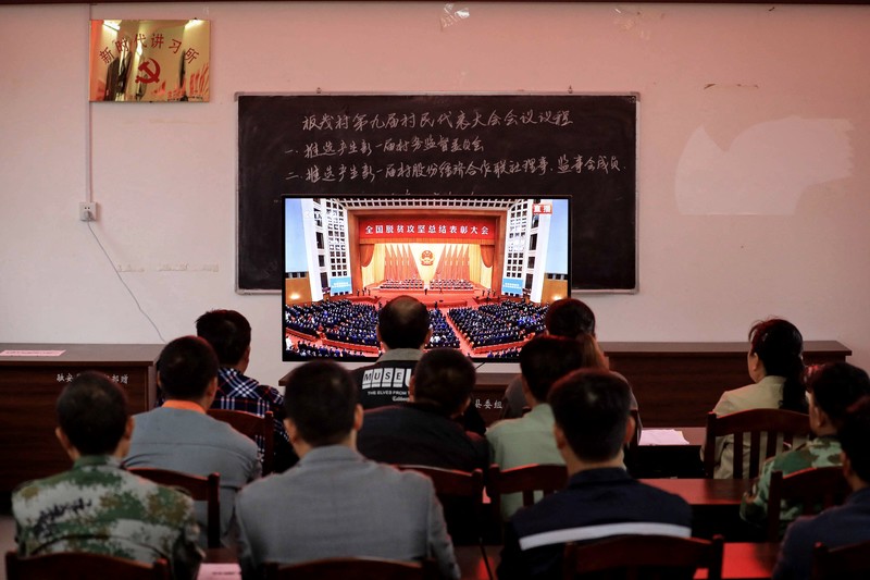 2021年2月，中國國家主席習近平宣布中國達成全面脫貧的目標。圖為廣西柳州一處村民代表會，大夥集體觀看「全國脫貧攻堅總結表彰大會」直播。（攝影／AFP／STR ）