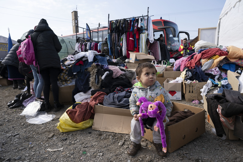 A Ukrainian child holds a donated stuffed animal at a refugee station in the Polish border town of Medyka on March 15, 2022. Dozens of aid stations were set up in the area by non-profit organizations and charity groups to provide food, toys, clothes, and other necessities for refugees who had fled the Russian invasion of Ukraine.  (Photo by Yang Tzu-lei)