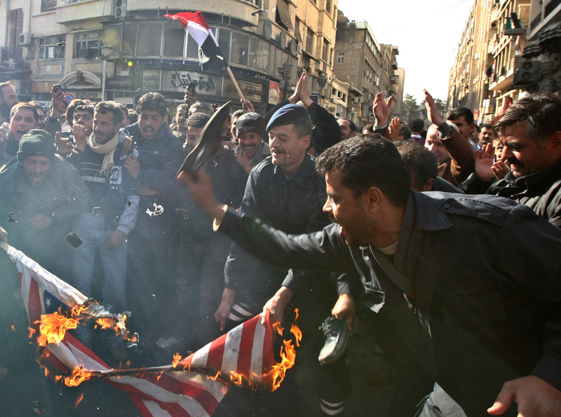 2008年12月28日，以色列對加薩走廊發動首波空襲，造成上千巴勒斯坦人傷亡的隔日，在敘利亞大馬士革街頭的示威者焚燒支持以色列行動的美國國旗，並用鞋子持續撲打旗幟。（攝影／AFP／Louai Beshara）
