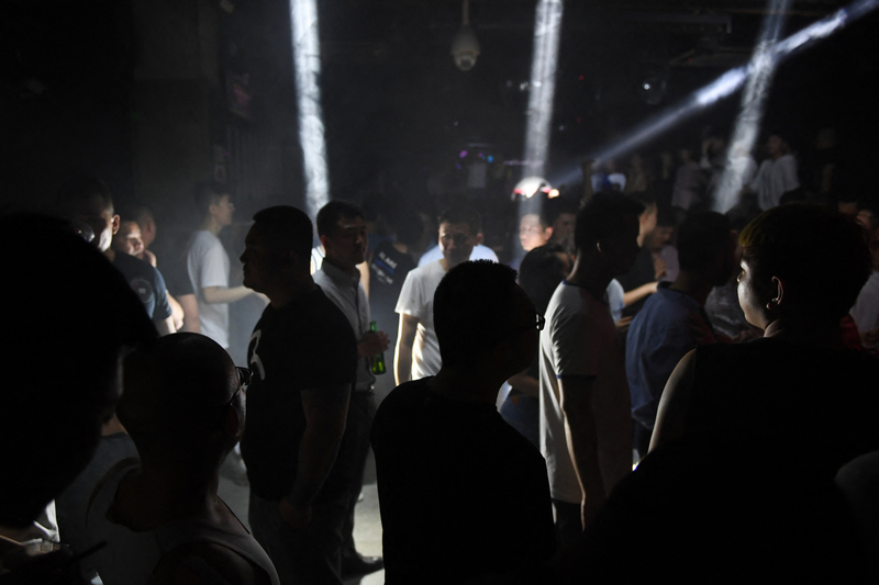 高壓環境之下，許多大學中的性少數社團轉入地下，艱難維持。圖為2019年5月，人們在北京一家同志夜總會中跳舞。（ 攝影／Greg Baker／AFP）