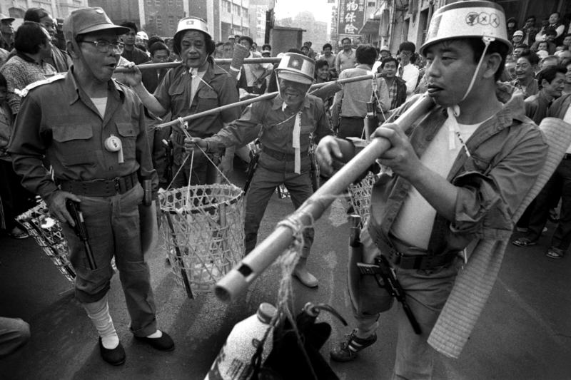 【1988.02.28  二二八遊行、台南市政府前】解嚴後為了追求二二八事件的真相，民間團體在台南發起的「二二八遊行」活動中，民眾以嘲諷似般裝扮成當時國民政府撤退的軍隊模樣。（攝影／謝三泰）