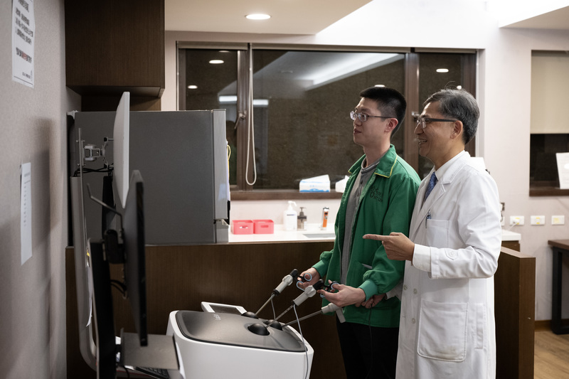 陳晉興指導學生操作外科手術模擬器。他每週帶領學生進開刀房、查房、討論病例並開研究會議,每個階段親自教學,期望學生從中感受到榜樣的力量,也願意踏上外科之路。(攝影/楊子磊)