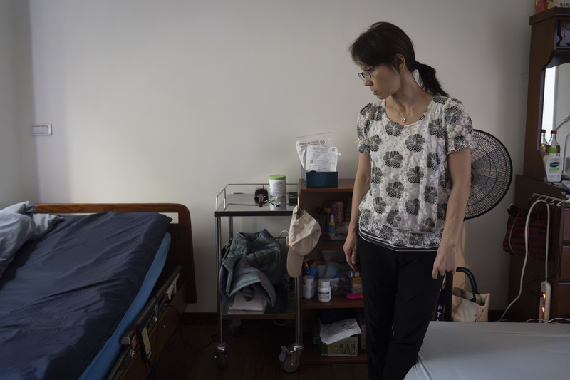 阿炎伯的二女兒一度住在醫院,向看護學習如何照顧父親,回家後一手操辦抽痰、換尿布。(攝影/陳曉威)