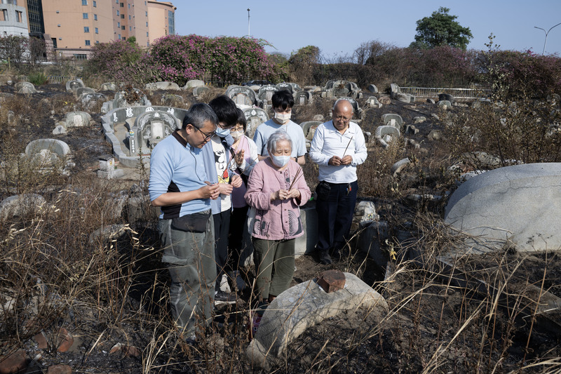 吳延晃（左）在參與南山公墓保存運動過程中，發現家族先人亦葬於此地，2026年2月18日，他帶著父母與妻兒來到先人墳前祭拜。（攝影／楊子磊）