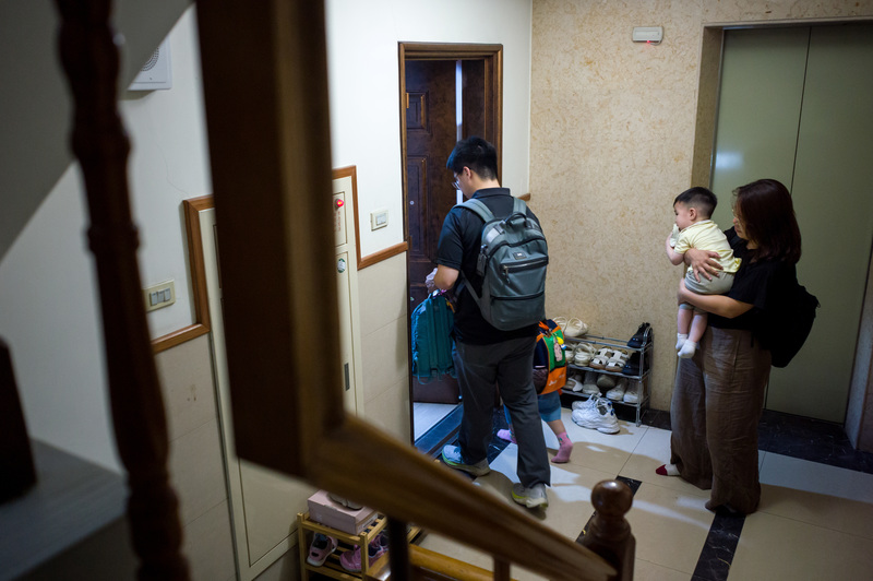 政府雖放寬申請外籍家庭幫傭門檻，但居住空間的限制與經濟能力，仍是多數中產階級難以跨越的門檻。圖為家長帶著孩童返家的混亂時刻。（攝影／黃世澤）